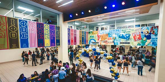 The pit at Graham Center showing a throng of students going about their day on campus. 